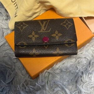 Louis Vuitton Black and Gold Monogram Wallet with Purple Button
